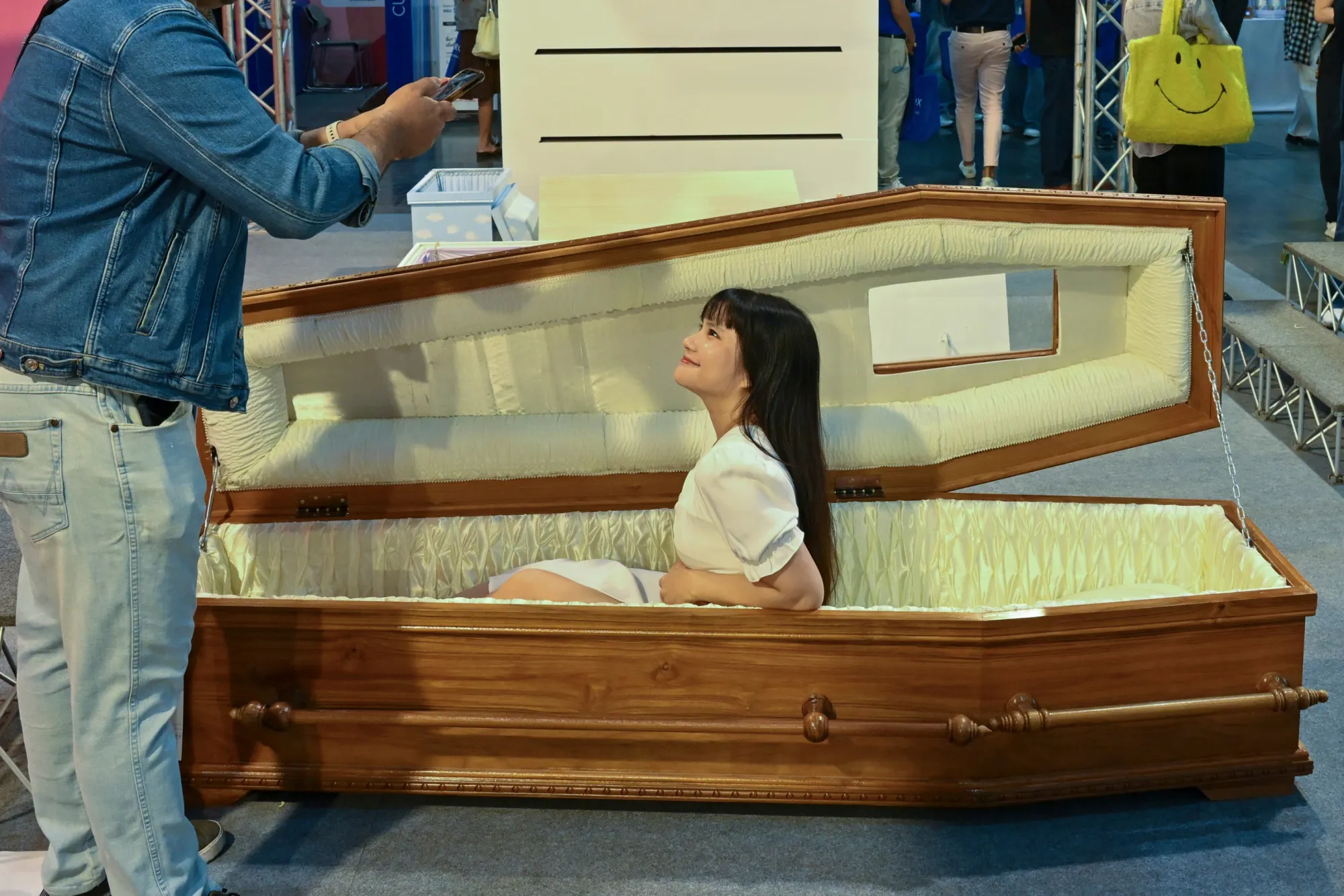 ผู้เข้าชมโพสต์ท่าถ่ายรูปนั่งในโลงศพที่งาน Death Fest จังหวัดนนทบุรี ประเทศไทย วันศุกร์ที่ 13 มีนาคม 2569 (AP Photo/กิตตินันท์ รอดสุพรรณ)