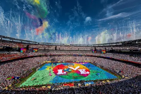 Getty Images A wide shot of the stadium with a colourful stage in the centre and the word 