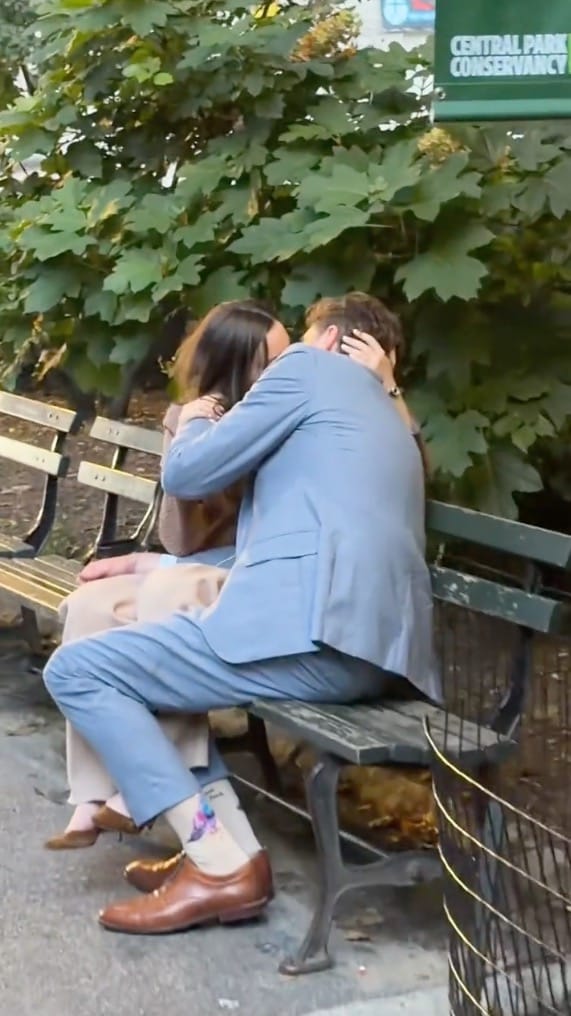 Kelsey Borenzweig and Nathaniel D. Cullerton kissing on a bench.
