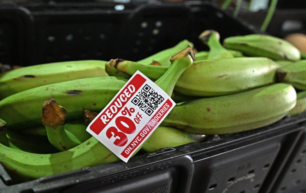 Green bananas with a red 