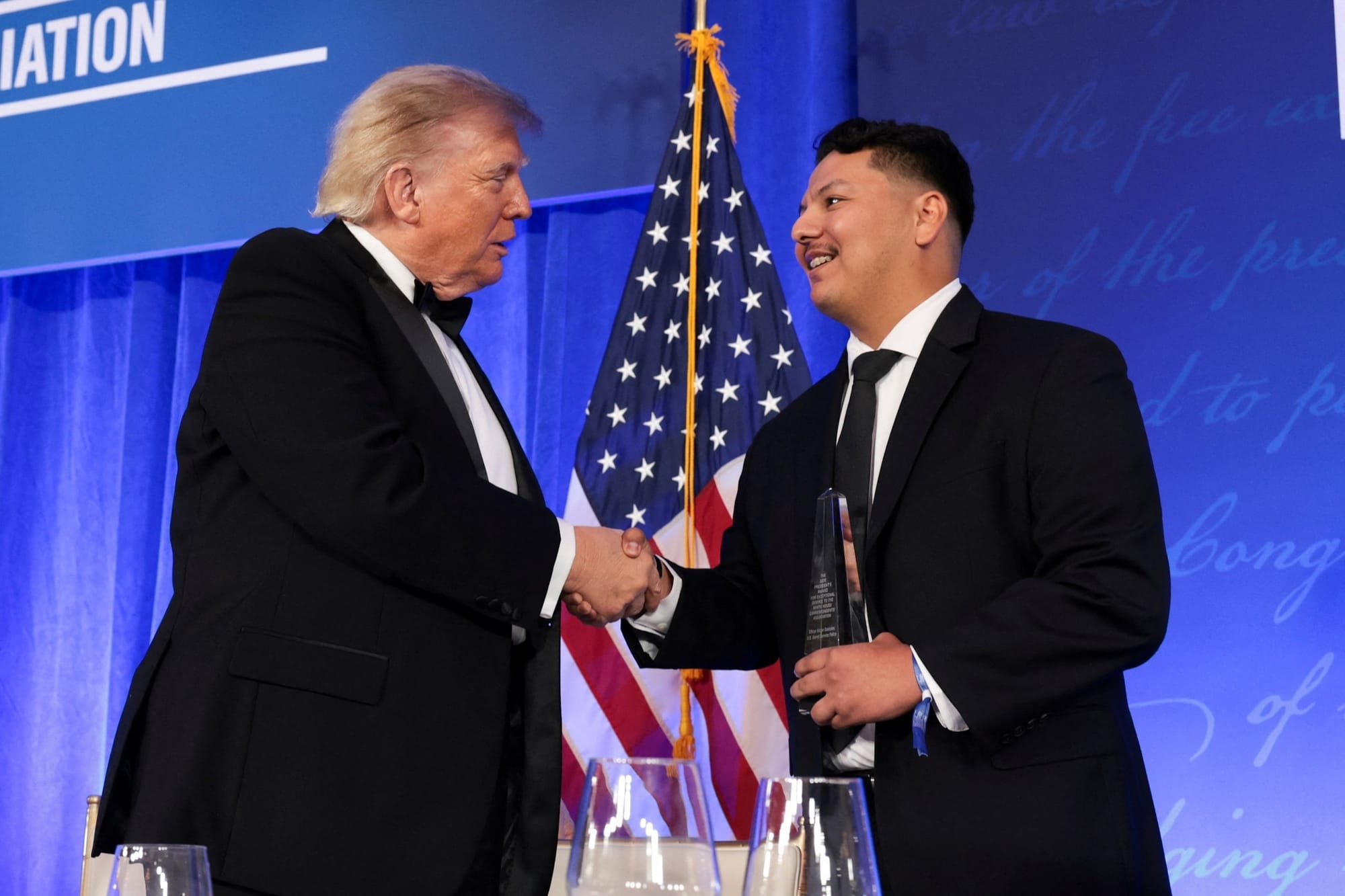 U.S. President Donald Trump shakes hands with Secret Service officer Victor Gonzales