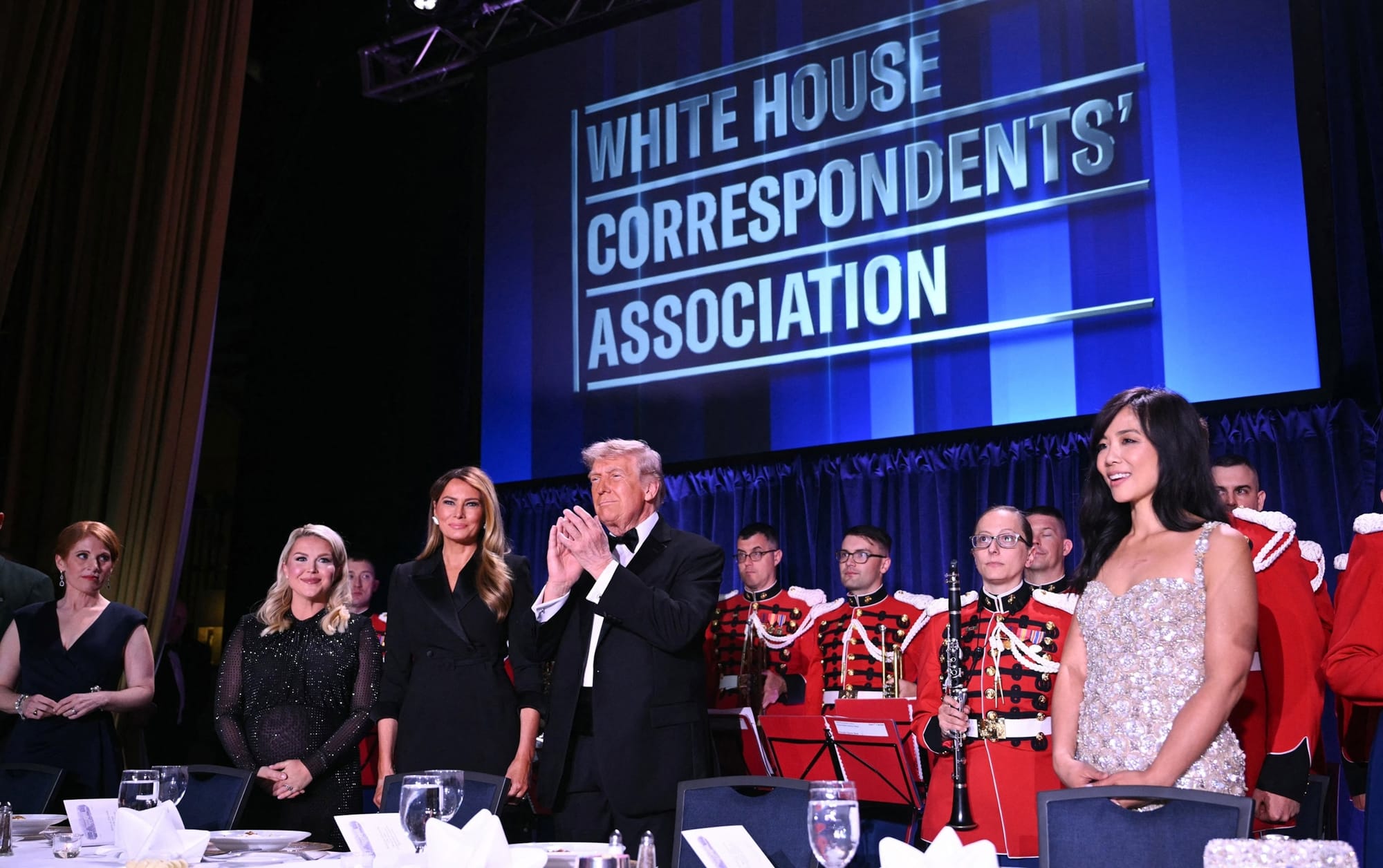 In this April 25, 2026, file photo, journalist Karen Travers, White House Press Secretary Karoline Leavitt, First Lady Melania Trump, President Donald Trump and CBS News correspondent Weijia Jiang attend the White House Correspondents' dinner