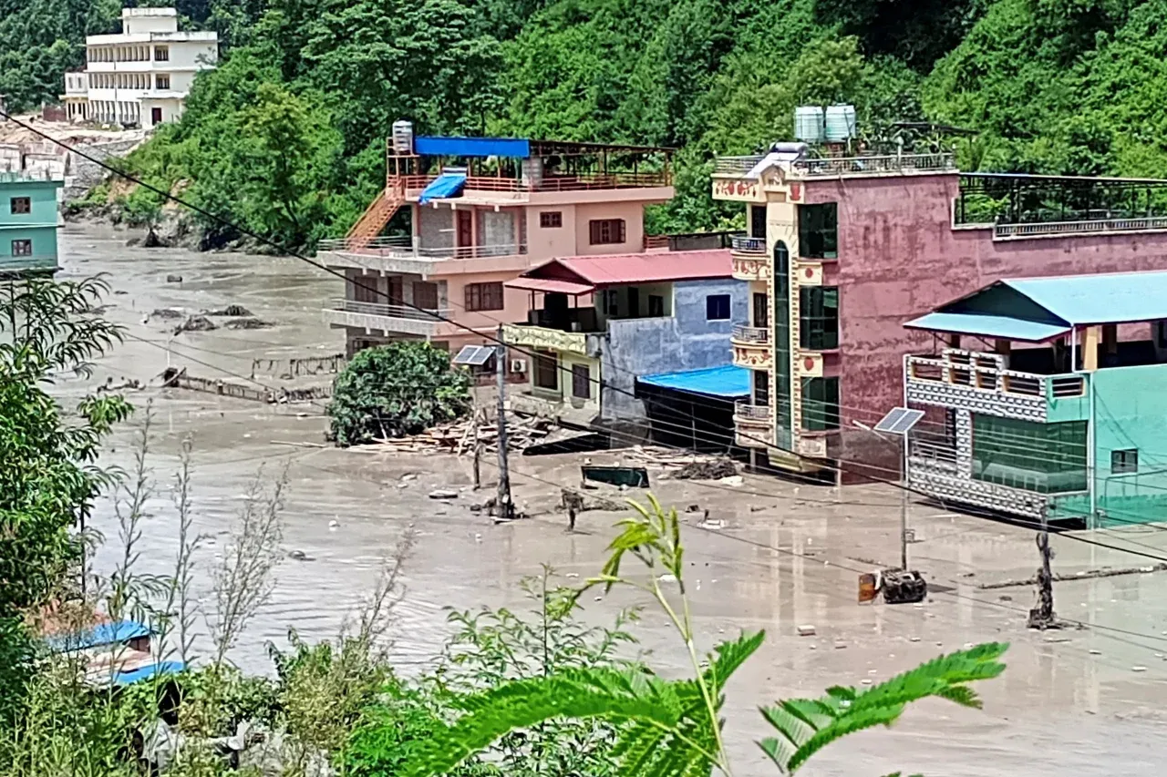 A torrent of muddy water surges through a river after flash floods at Galchhi in Nepal's Dhading district