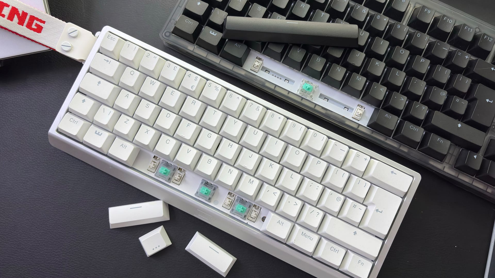 The Wooting 60HE v2 with a split spacebar on a desk alongside the Wooting 80HE with a normal spacebar