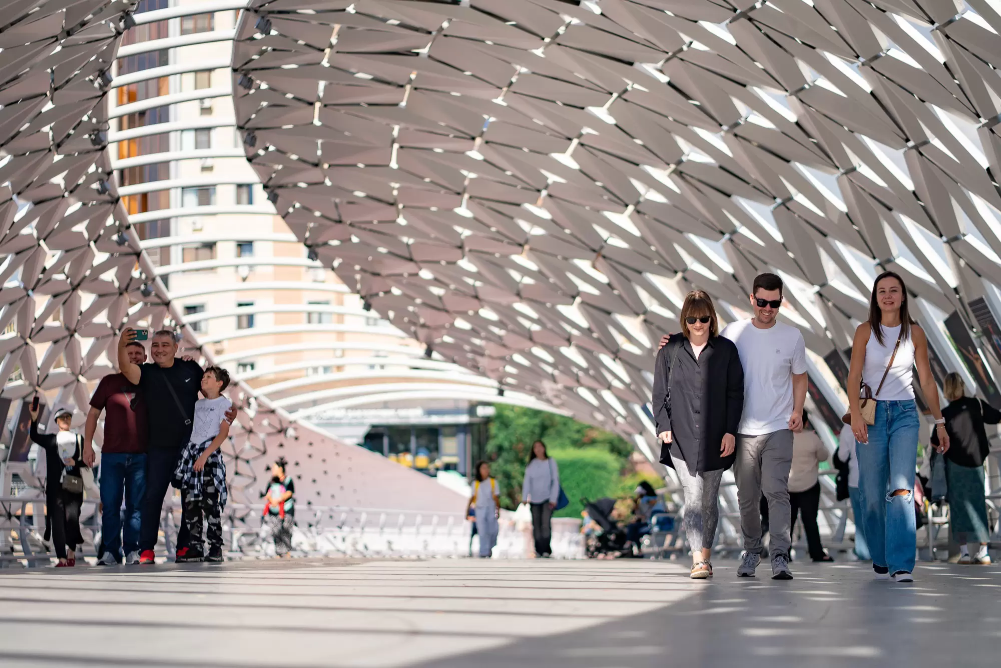 People walk on a pedestrian bridge in Astana, Kazakhstan