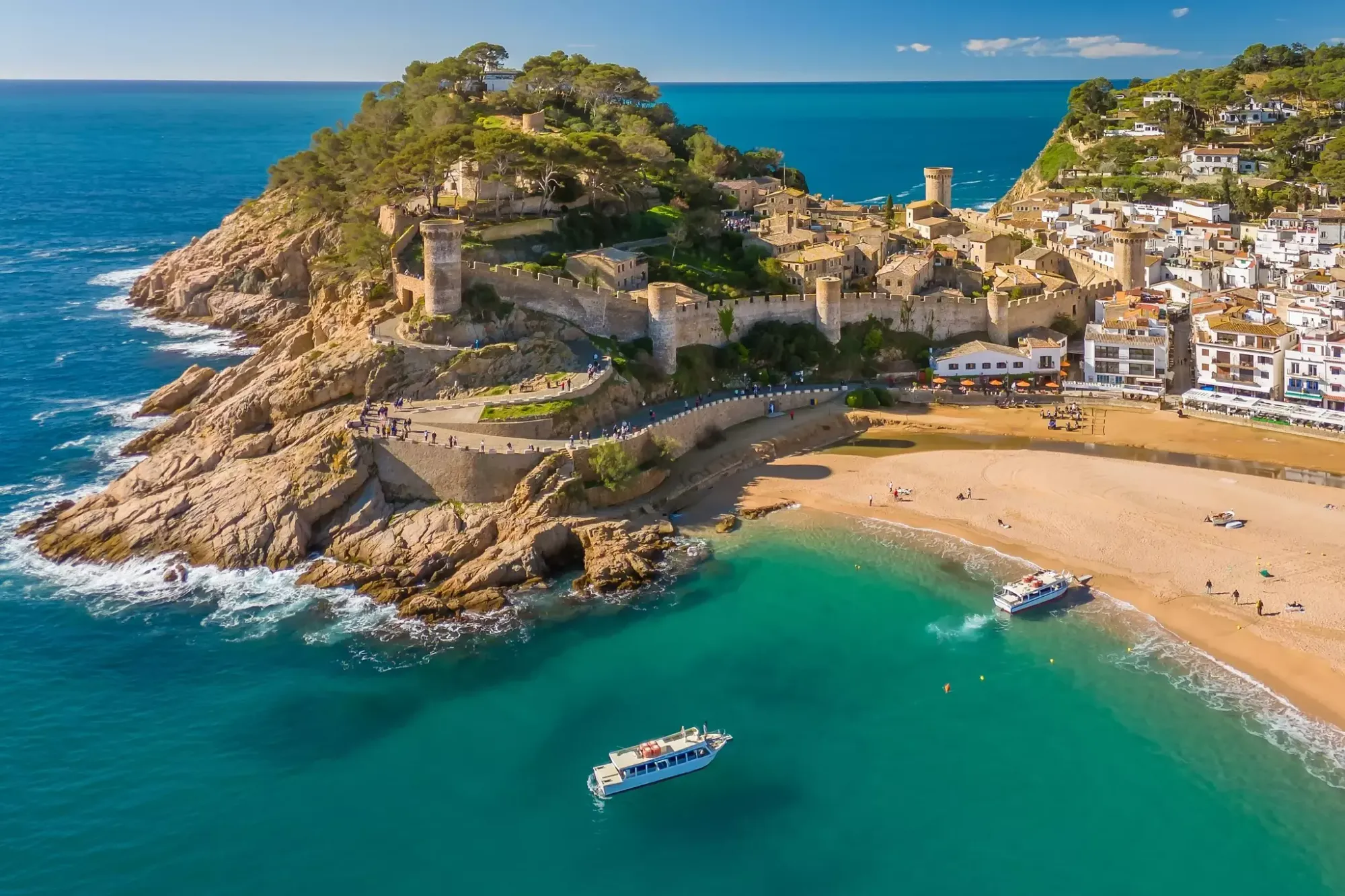 An aerial view of boats approaching the beach at Tossa de Mar