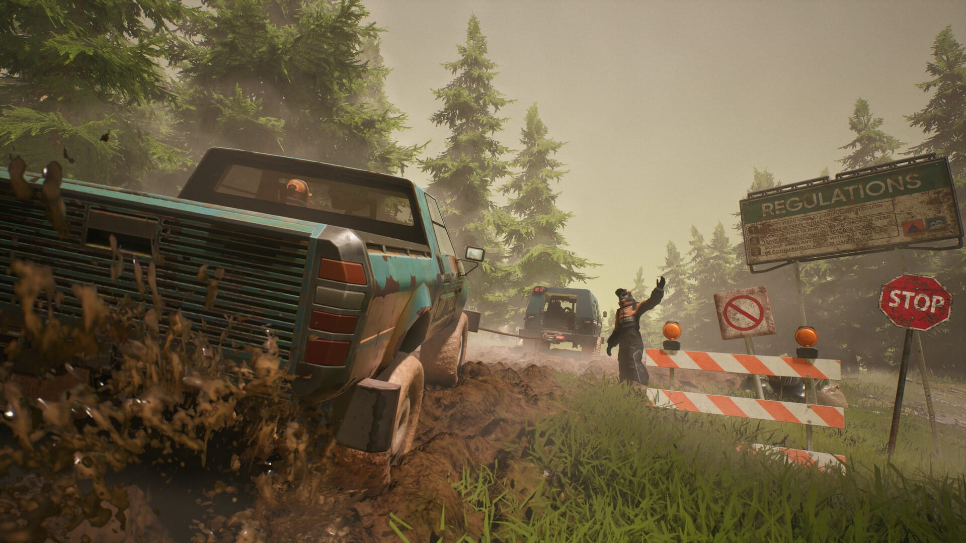 A truck stuck in the mud on the side of a road