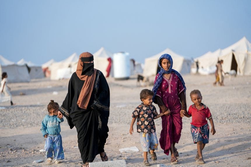 Women and children who fled fighting between the Houthis and government forces in Red Sea coastline areas walk at a camp for internally displaced people near Aden, Yemen, on September 19.