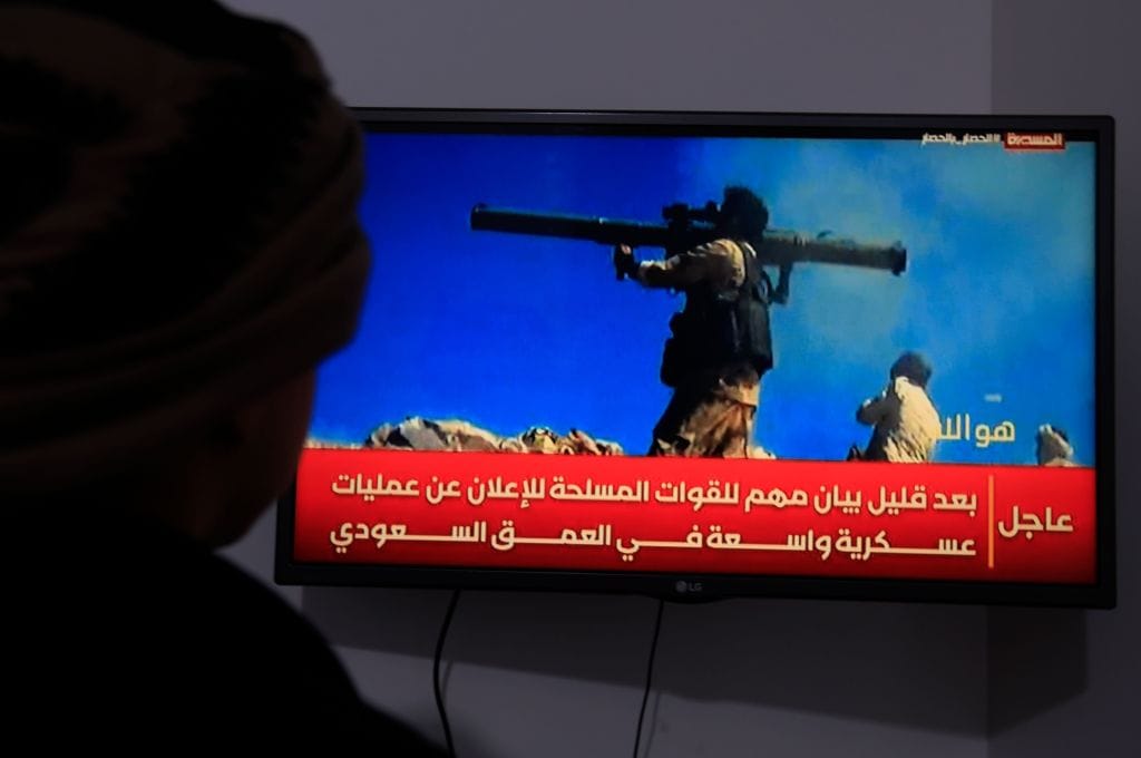 A person watches a TV broadcast on the latest developments in the Saudi-Houthi conflict in Sana'a, Yemen, on Sept. 19, 2026.