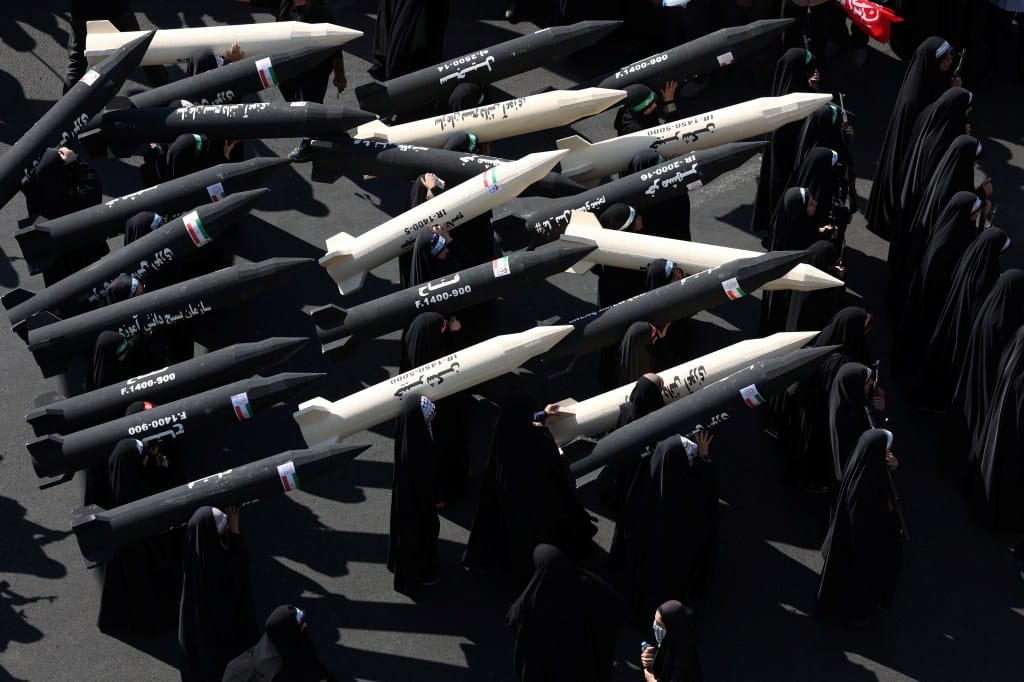 Female members of Iranian Basij militia carry missile mock-ups during a military march in Tehran.